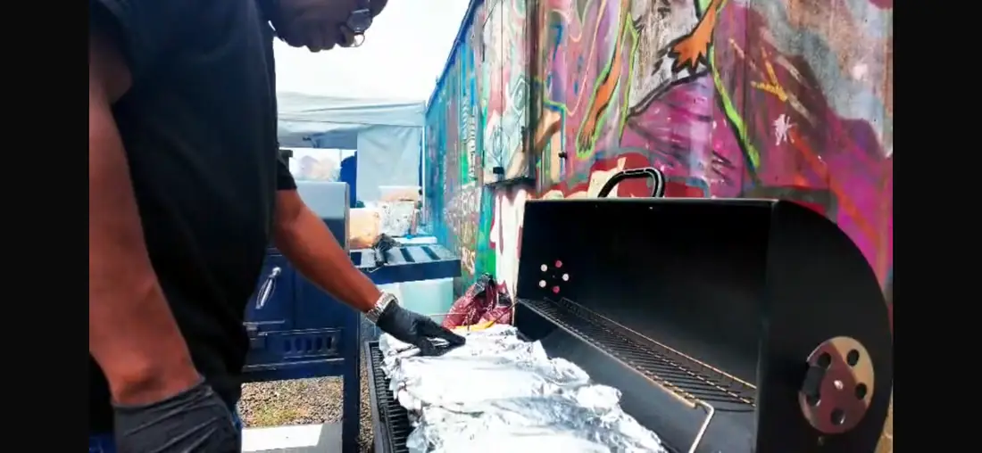 Outdoor catering station beside a smoker