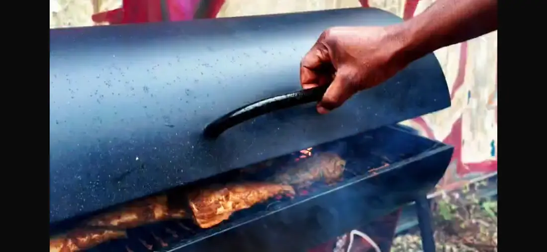 Smoker lid opening over grilled food