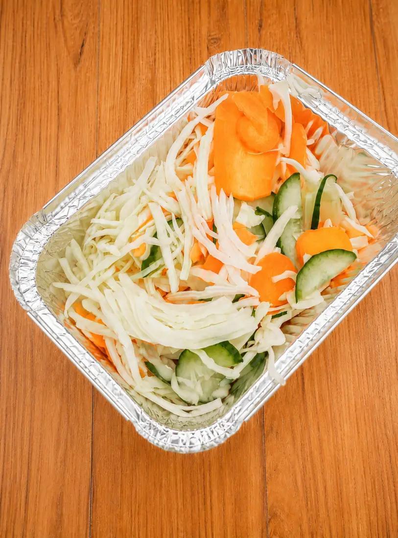 Fresh salad in a foil tray