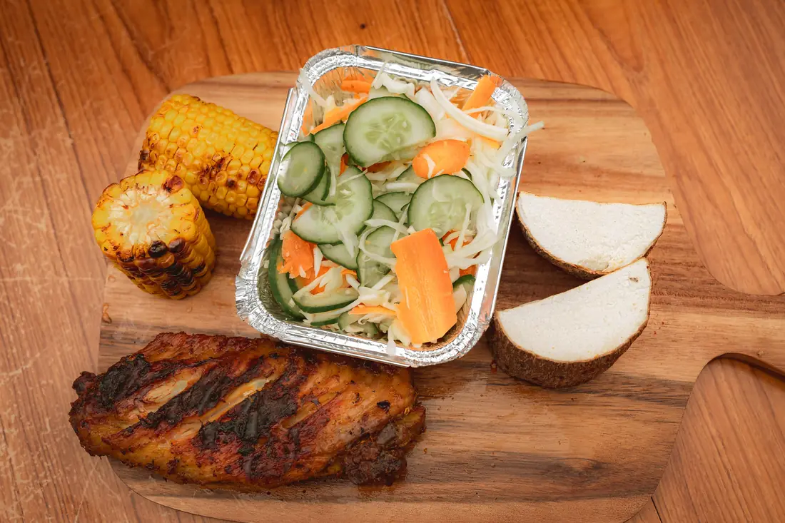 Turkey meal with yam, salad, and roasted corn